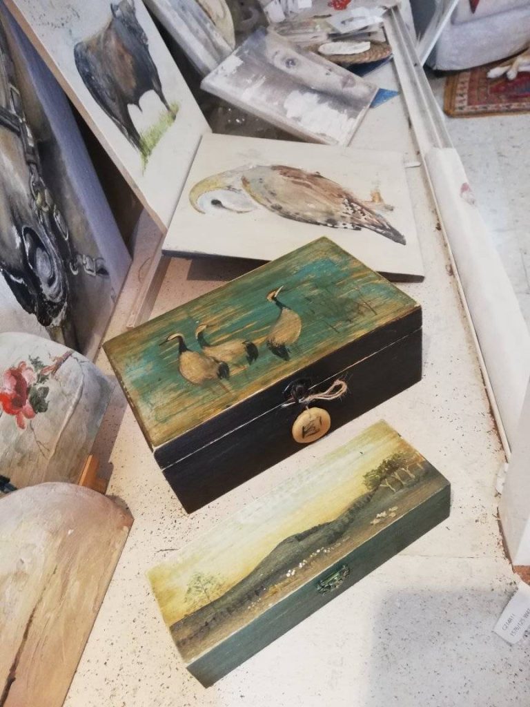 Cajas de madera decoradas a mano con pinturas de aves y paisajes en MP Estudio de Interiores.